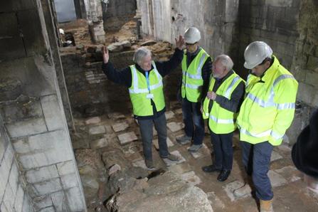 four man discussing a Roman dry sweat room 